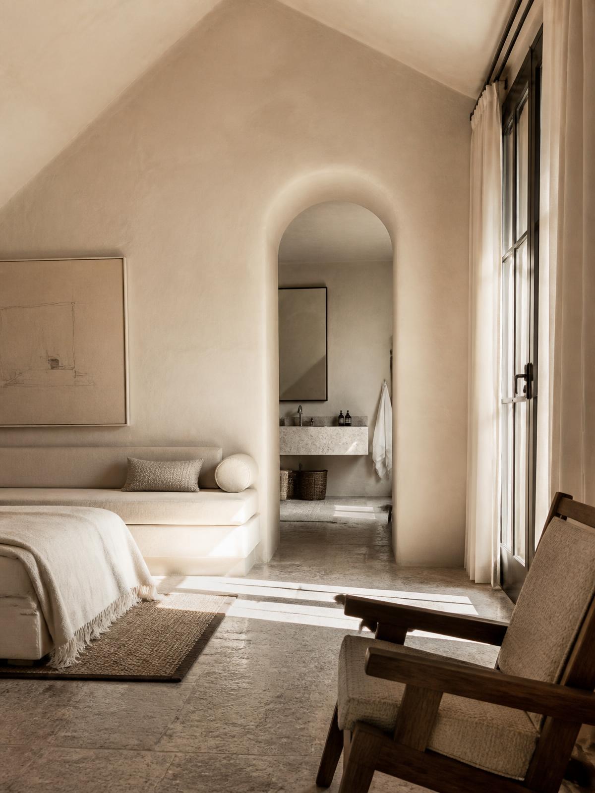 Plaster walls, linen and daylight across a stone floor